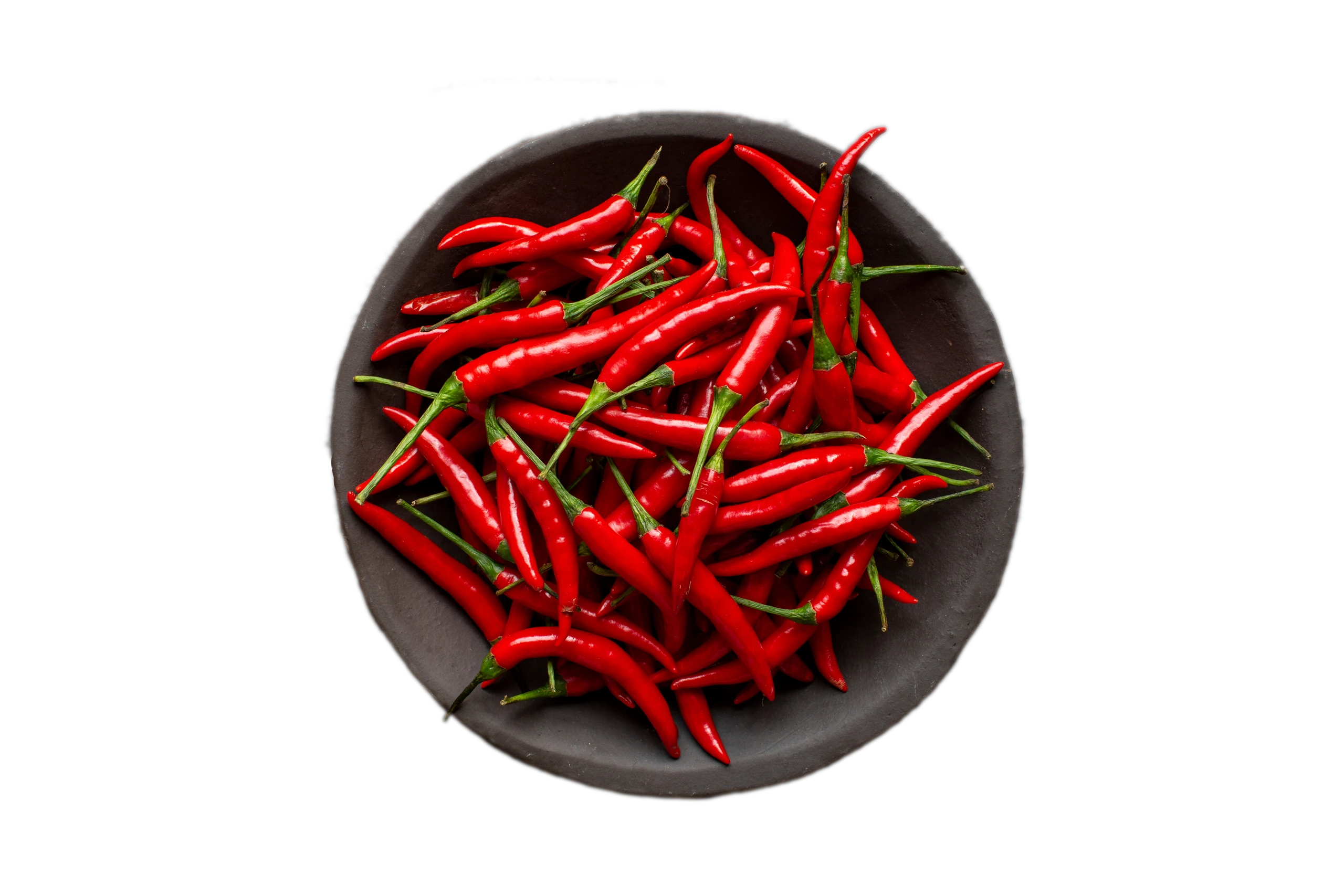 Red chilies in a bowl on a slate surface